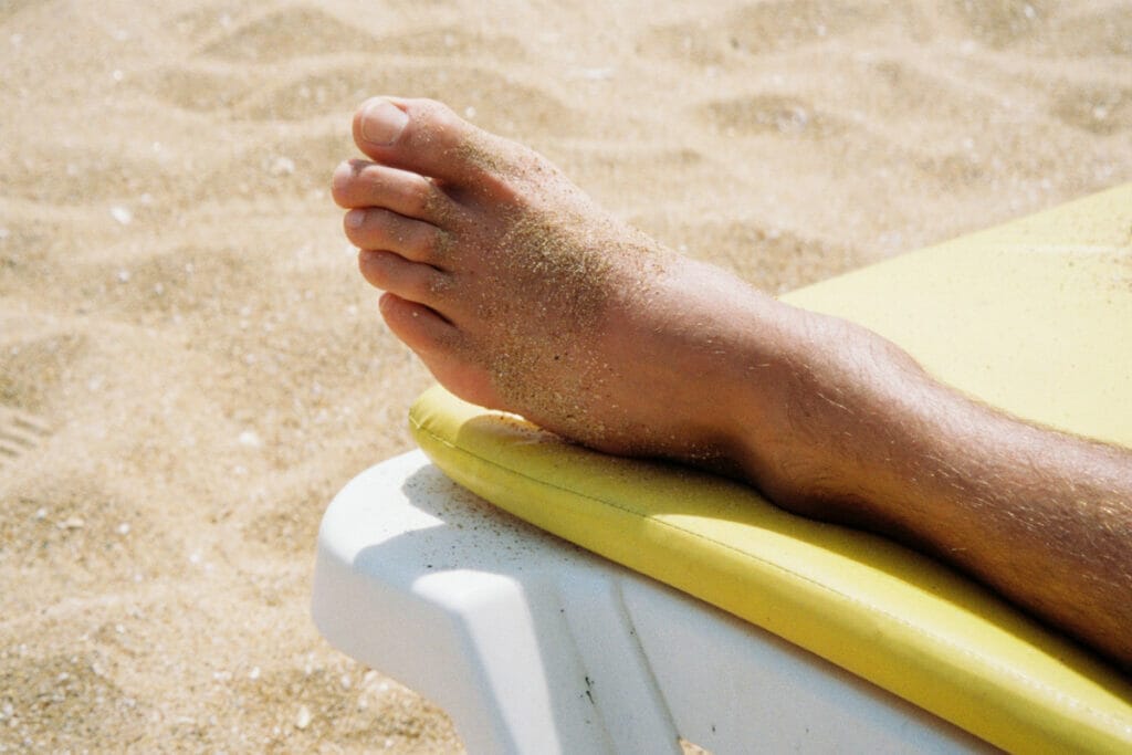 foot with sand on it