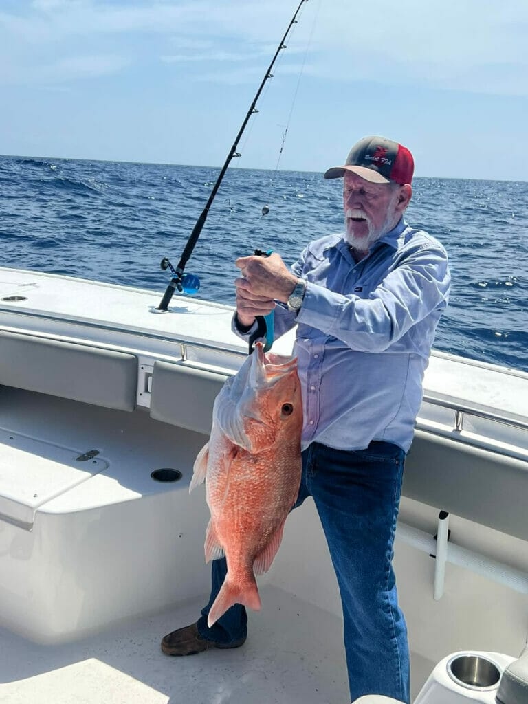 Man fishing on the Gulf Coast Fishing Charter boat