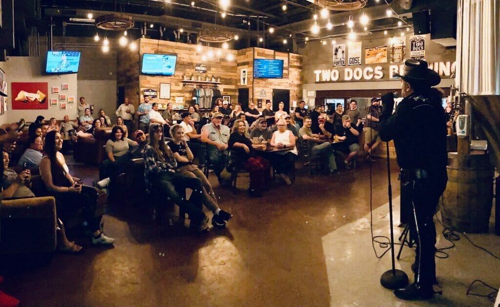 Comedian performing in front of a crowd at the Laugh Hub City