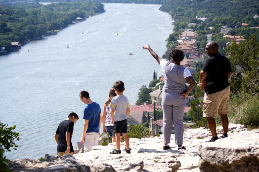 People standing on top of Mount Bonnell