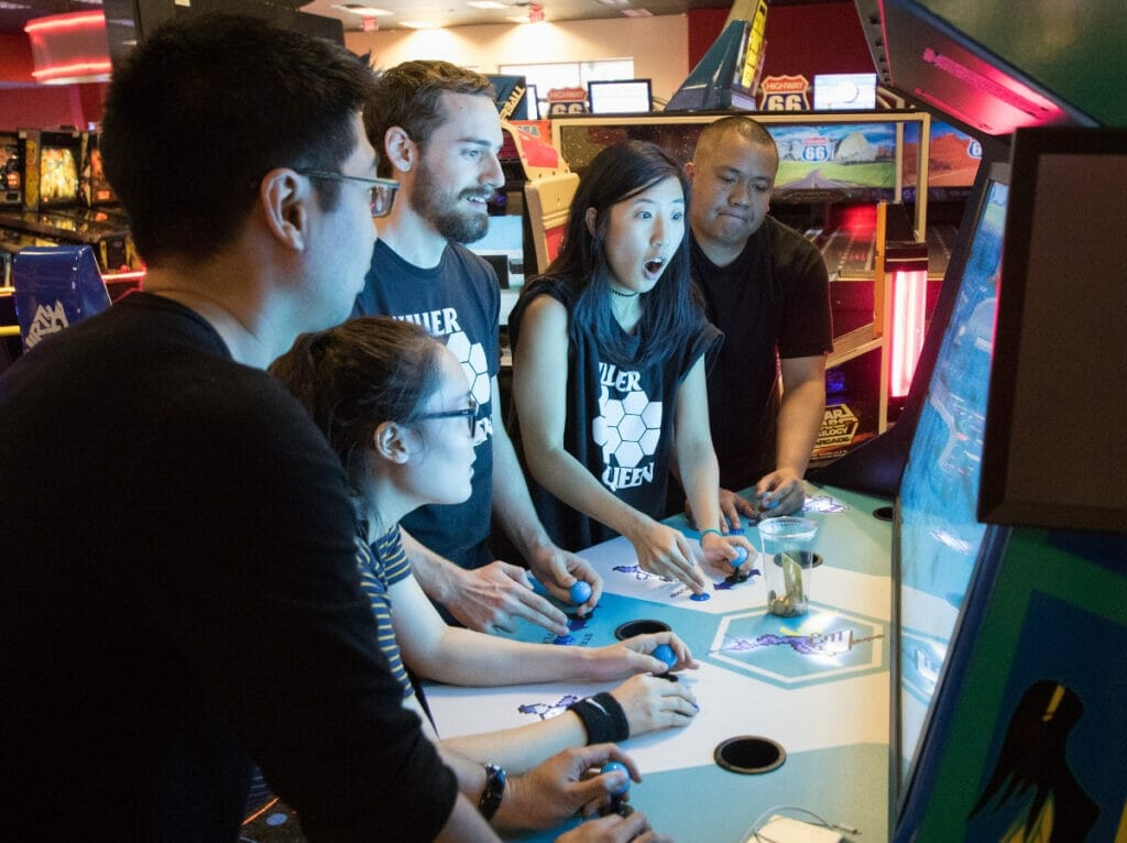 People playing pinball 