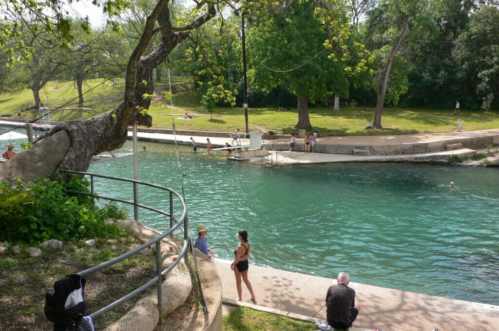 People swimming at Barton Springs Pool in Austin TX