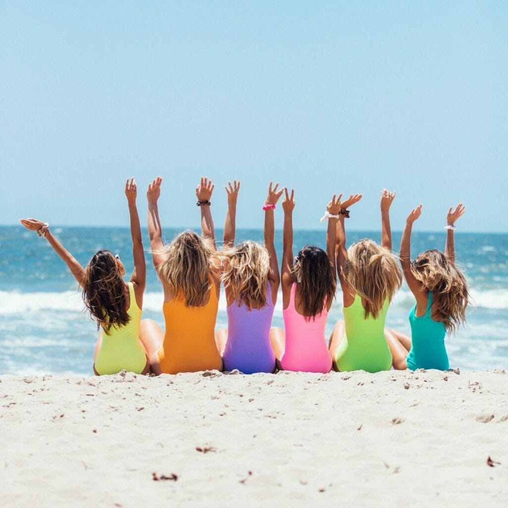 Girls sitting on the beach together 