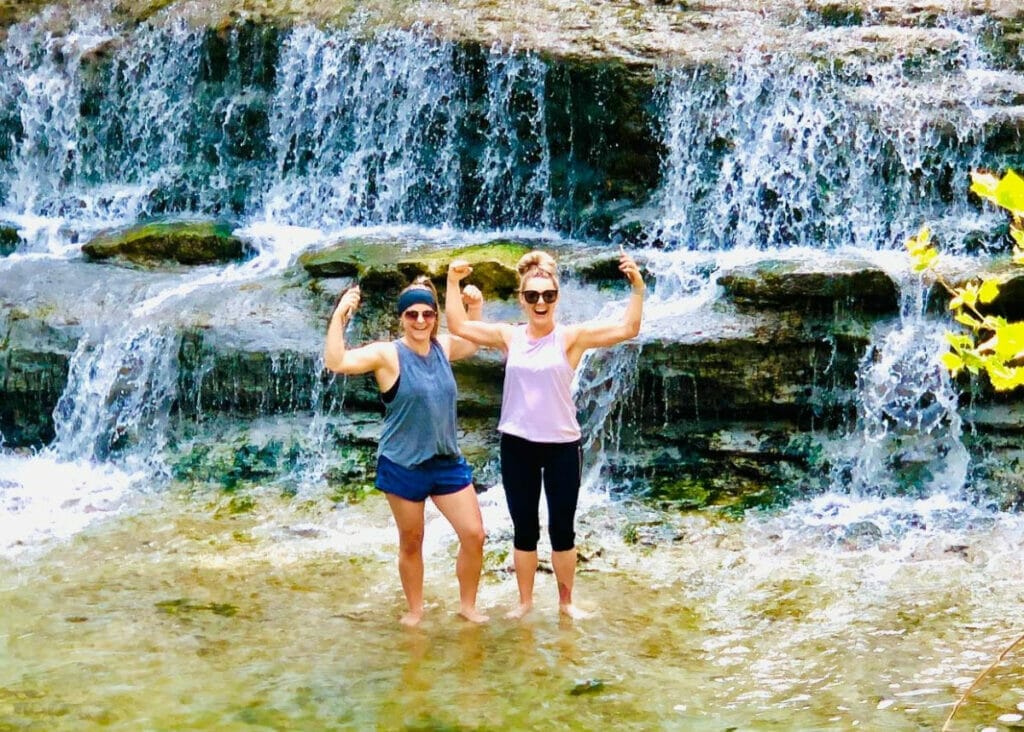 Ladies standing in front of waterfall at Chalk Ridge 