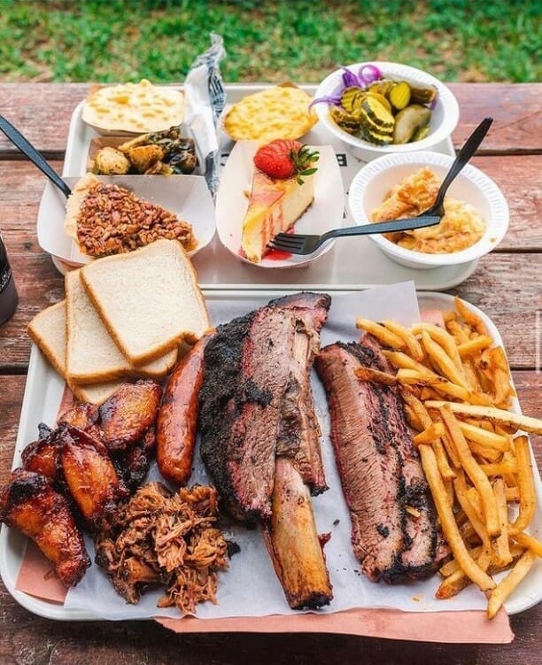 Killen's Texas BBQ platter with barbecue, french fries, chicken, pecan pie, and veggies 