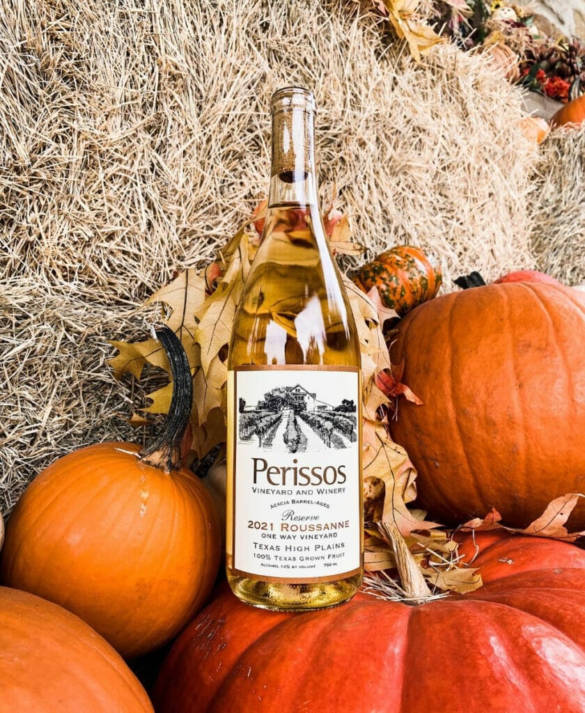 Perissos wine bottle on top of a pumpkin patch