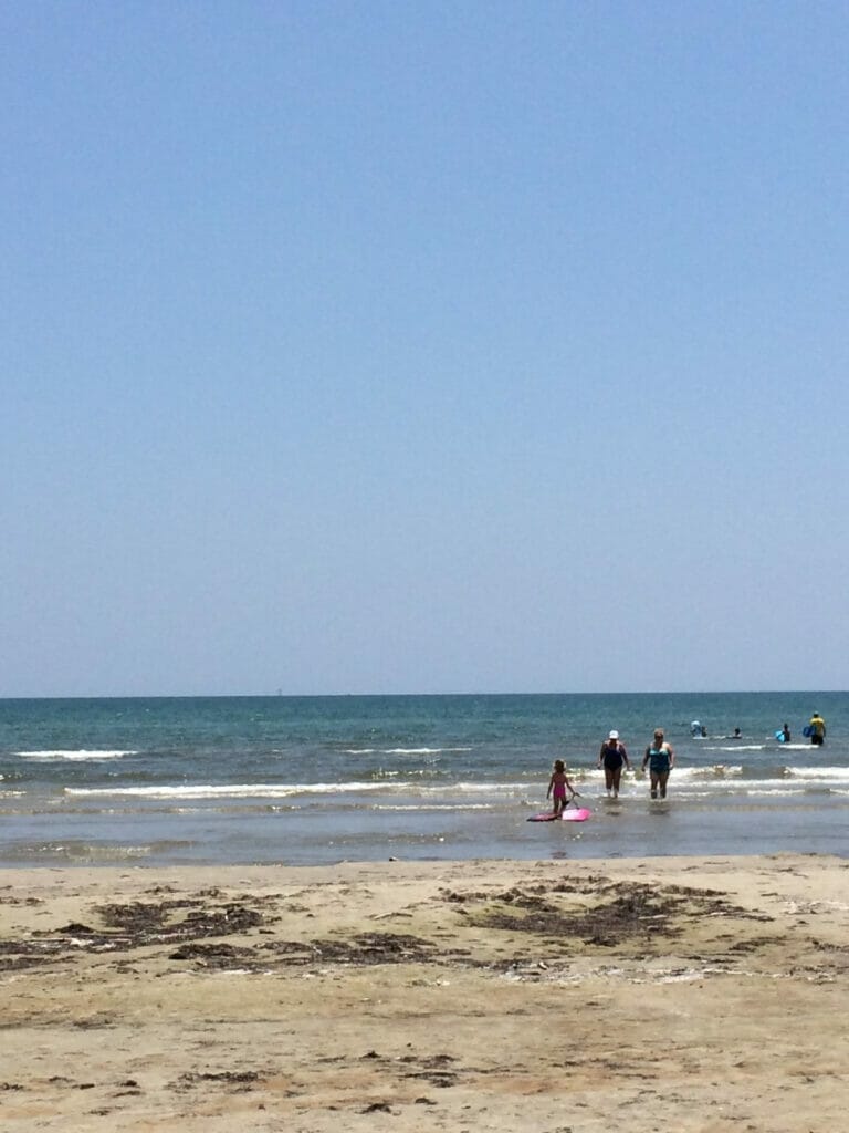 People walking in the sand at Rockport beach